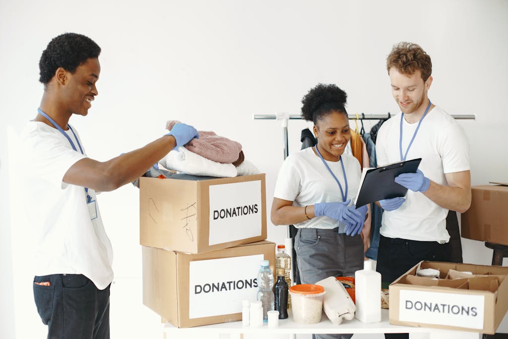 Dedicated volunteers sorting donation boxes indoors for community support.